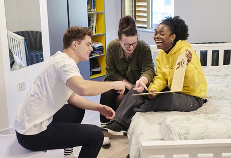 Three students laughing in Mithras halls of residence