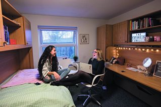 Two students laughing in university accommodation