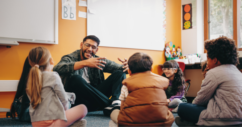 Primary school teacher speaking with pupils