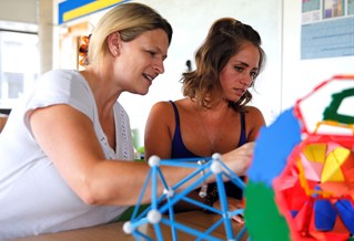 Liz Wright and Sabena Bond working at a table in a school