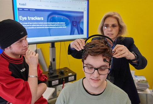 Sanaz with students using eye tracking equipment