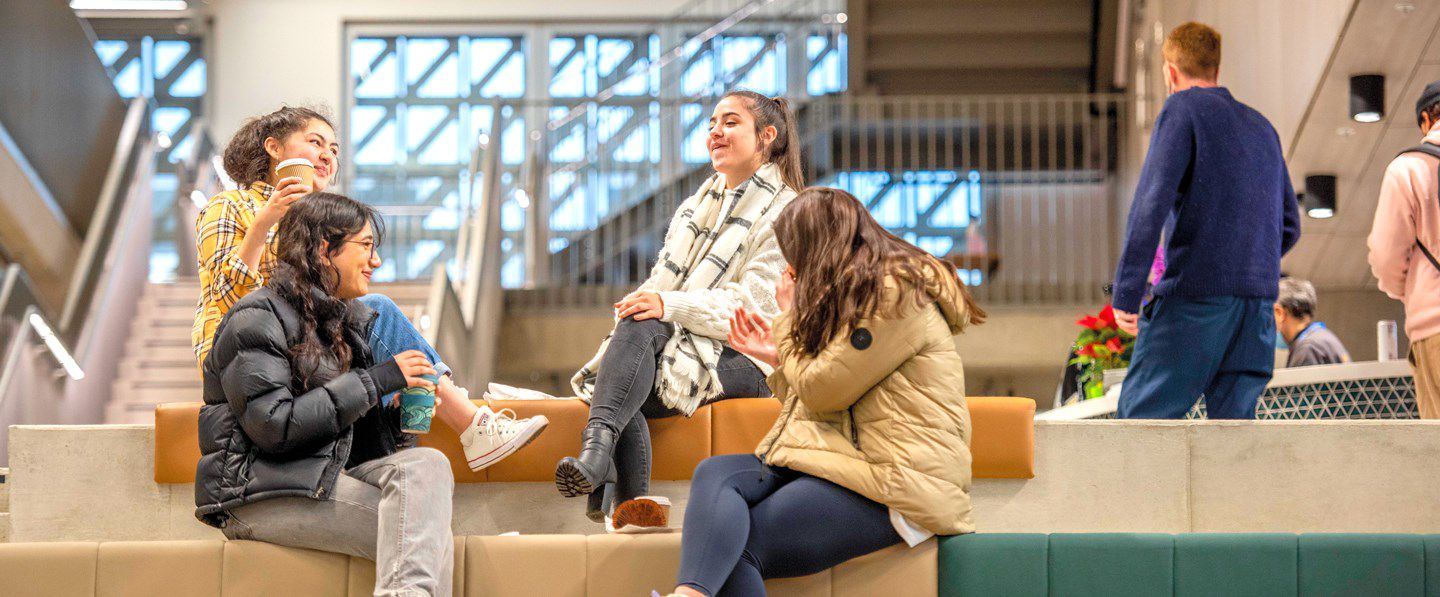 Students sitting on stairway seating in Elm House