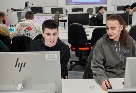 Two students working together in a computer lab