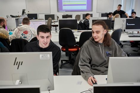 Two students working together in a computer lab