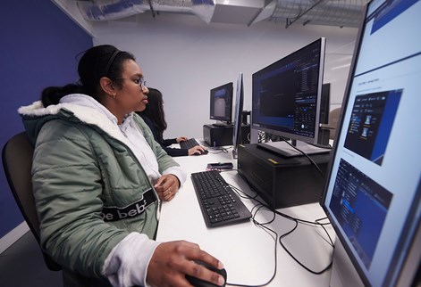 Two students in a studio working on game design