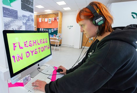 A student prepares their graduation show work on a computer