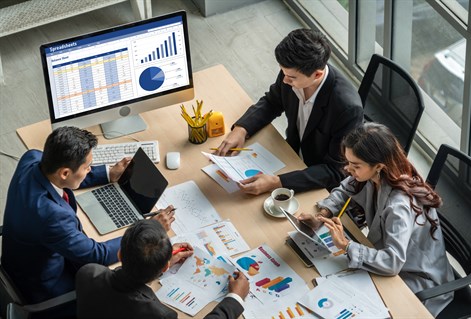 Group of colleagues looking at graphs