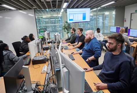 Students working from computers in Bloomberg suite