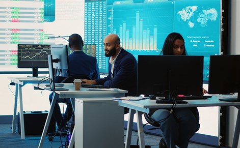 work colleagues sitting in trading office