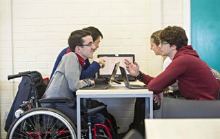 Student using a wheelchair working on computers