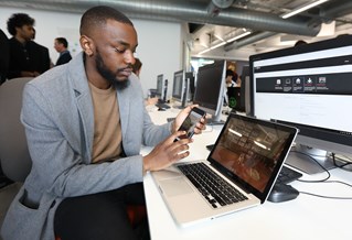 Male student working on app in front of computer