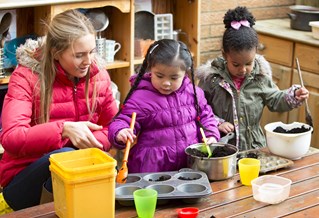 adult and children in a nursery school doing activities