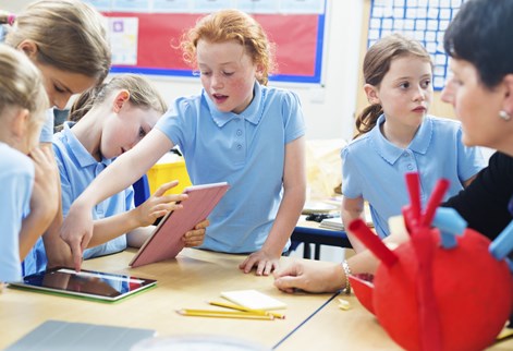 Group of children in blue uniform in classroom