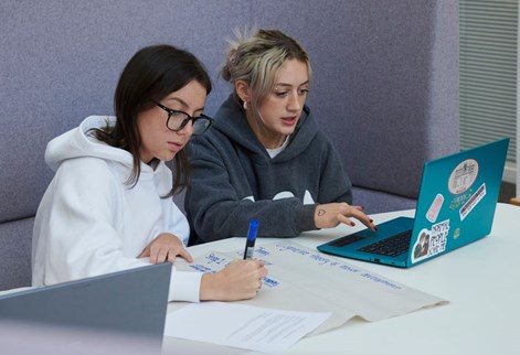 Childhood education students working from laptop