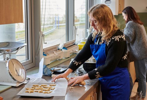 student placing buscuits on a tray ready for cooking