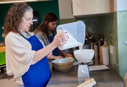 student weighing flour