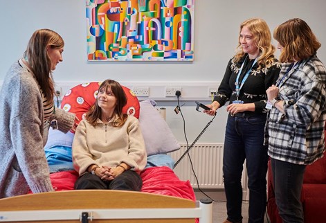 students being shown how to operate hospital bed