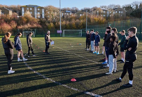 students being instructed on the all weather pitch