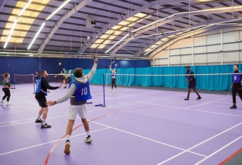 students learning to play badminton