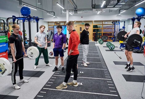 student demonstrating weight lifting