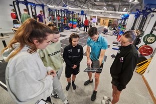 students and lecturer in the gym