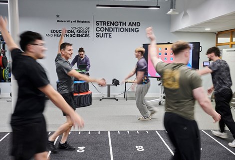 students running round the track in the strength and conditioning suite