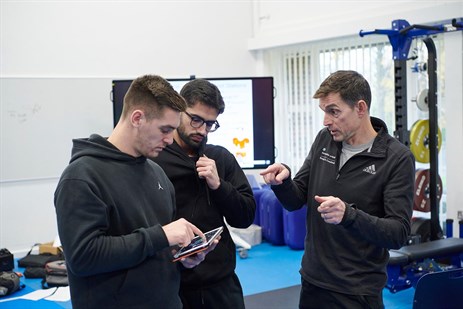 students with lecturer in the gym