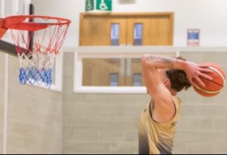 student playing basketball