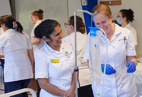 Student nurses practising catheterisation