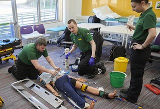 student paramedics with a mannequin