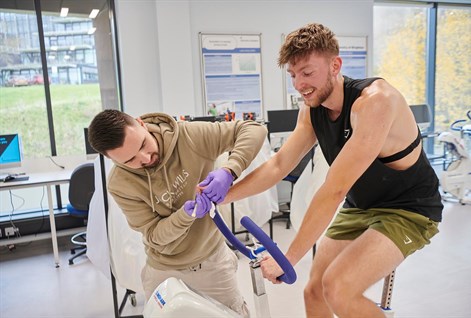 student on a bike having his blood taken