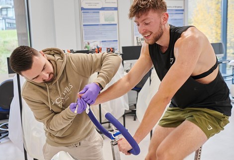 student on a bike having his blood taken