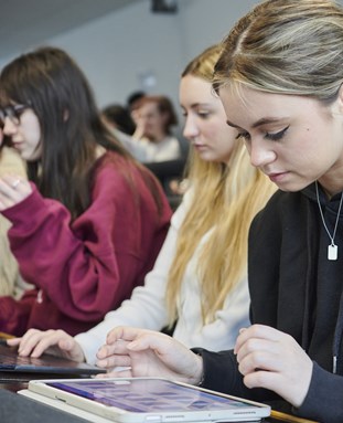 Students in class using laptops and ipads