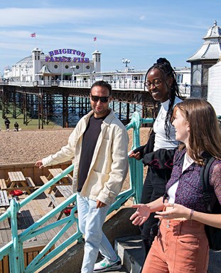 Students on Brighton seafront by the Palace Pier