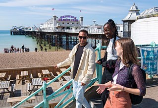 Students on Brighton seafront by the Palace Pier