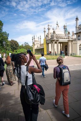 Student taking a photo of the outside of Brighton Pavilion