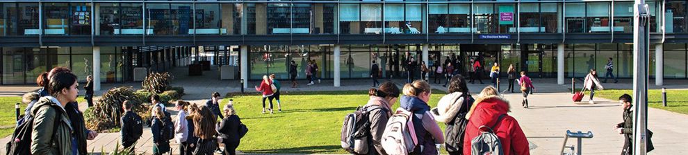 Students outside the Checkland Building at Falmer