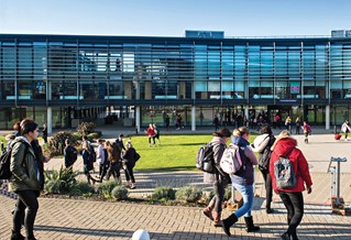 Students outside the Checkland Building at Falmer