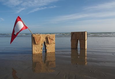 Stones and flag on the beach