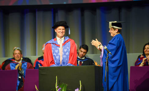 Martyn Davies CBE receiving his honorary doctorate from Professor Debra Humphris, Vice-Chancellor