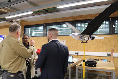 Joshua Gere with colleagues and the drone prototype