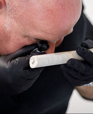 Professor Dave Nash analysing the sarsen core extracted from Stone 58 at Stonehenge. Photo by Sam Frost, English Heritage