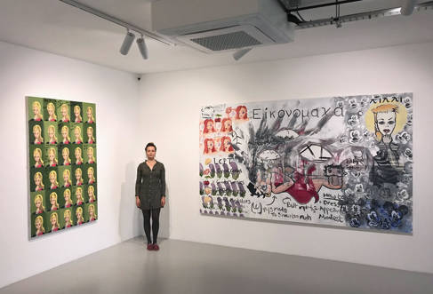 Verity Baird standing next to her pictures