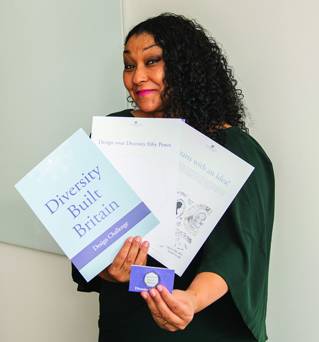 Dominique Evans with a Diversity Coin and Education Pack