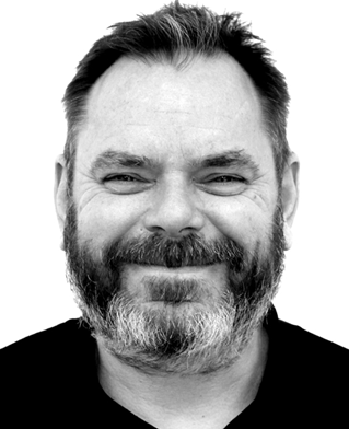 Head and shoulders black and white portrait of design researcher Nick Gant