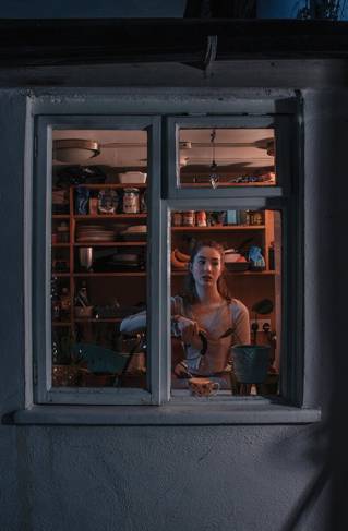 Woman at a window viewed from outside