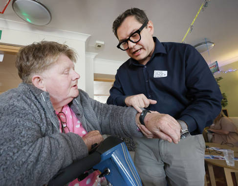 Dr Theo Fotis with a person wearing a sports watch