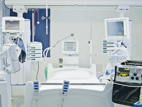 Empty hospital bed in intensive care