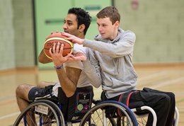 Two students playing wheelchair basketball